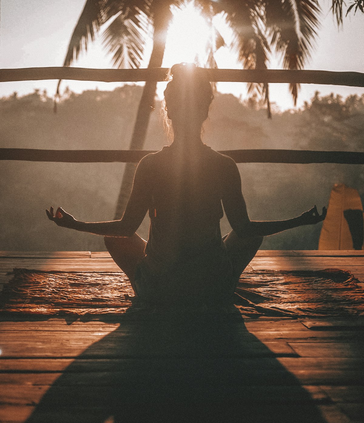 A person meditating at sunrise, embodying Vedic balance and inner peace